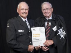 Des (left) receiving an award for 35 years from Graeme Mangin, a Commander of the order of St John