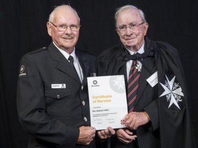 Des (left) receiving an award for 35 years from Graeme Mangin, a Commander of the order of St John